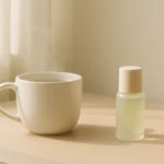 A woman smiling as she slowly makes a cup of tea in her sunny kitchen, practicing a calm morning routine.
