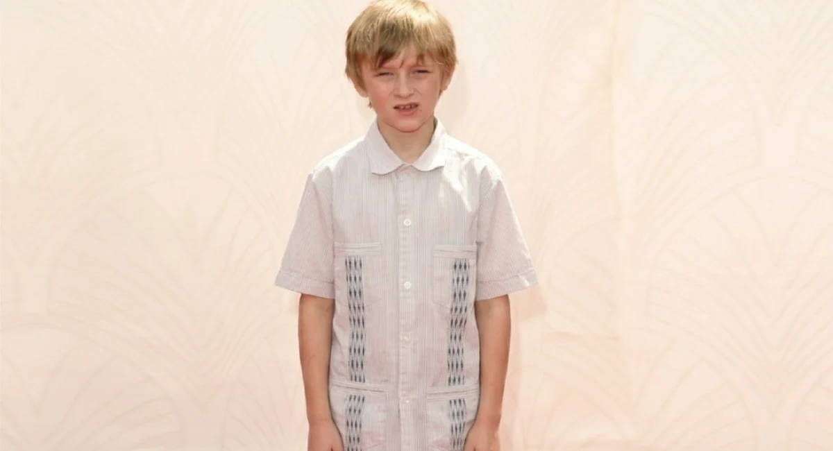 Will Theron Roth as a young boy at a public event wearing a white shirt